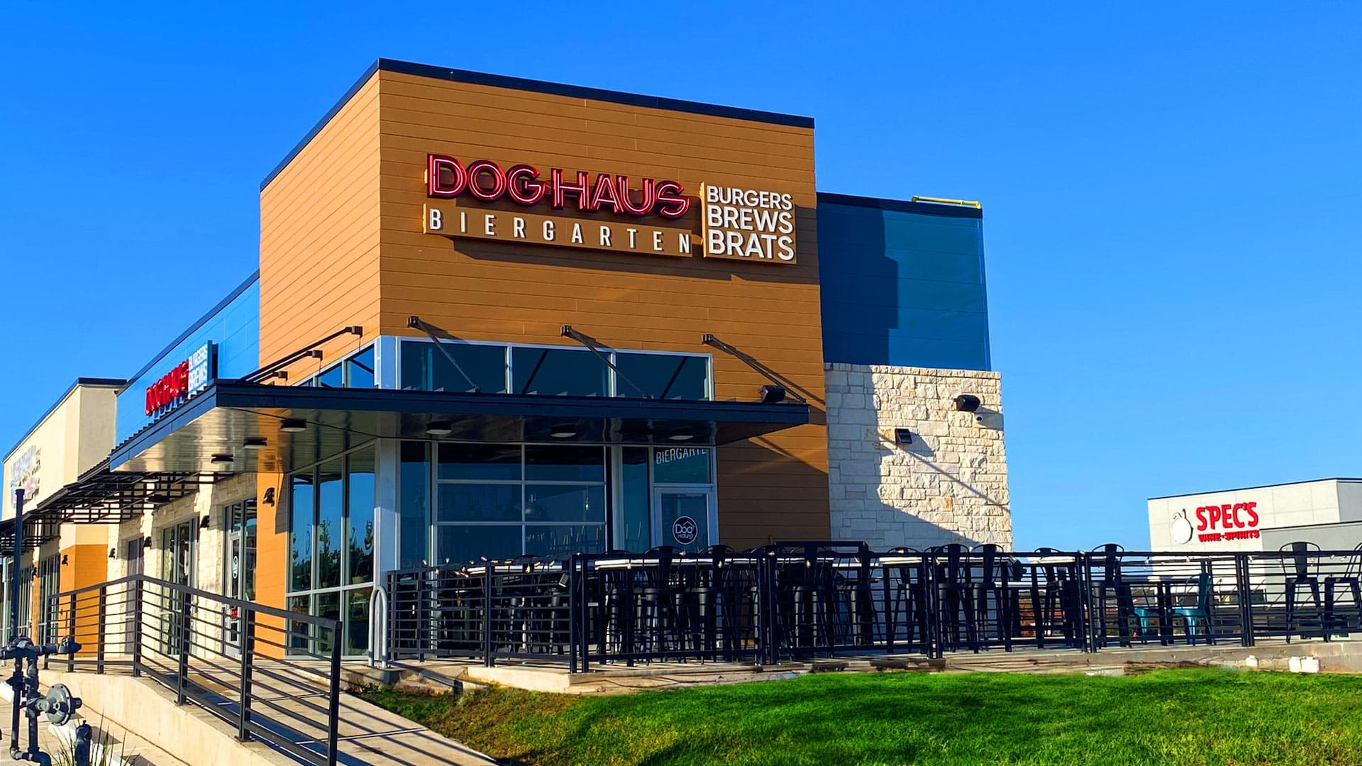 Dog Haus Biergarten exterior in Cedar Park with modern architecture, outdoor patio seating, and clear branding for burgers, brews, and brats.