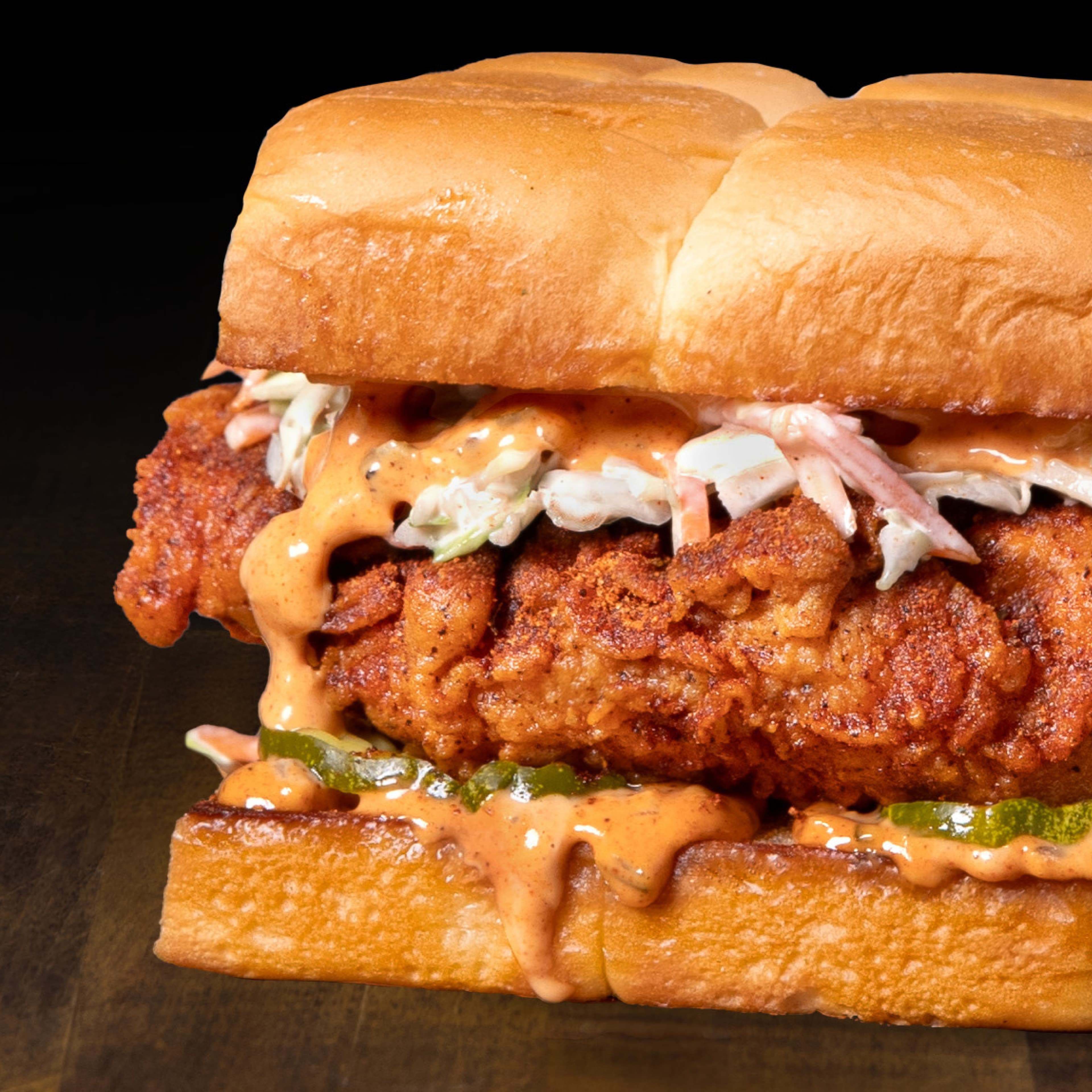 Fried chicken sandwich with slaw and spicy sauce